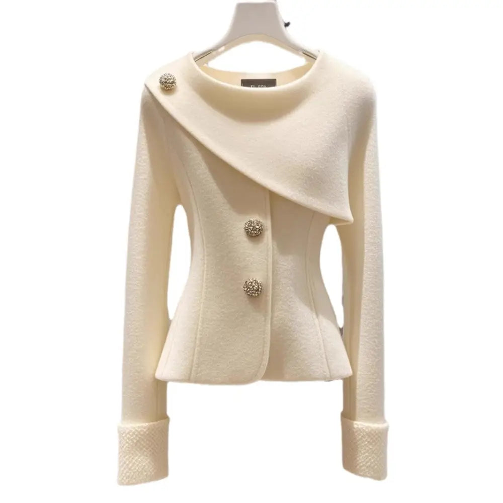 Elegant ivory jacket with decorative buttons.