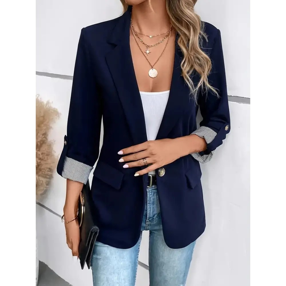 Navy blue blazer with rolled-up sleeves.