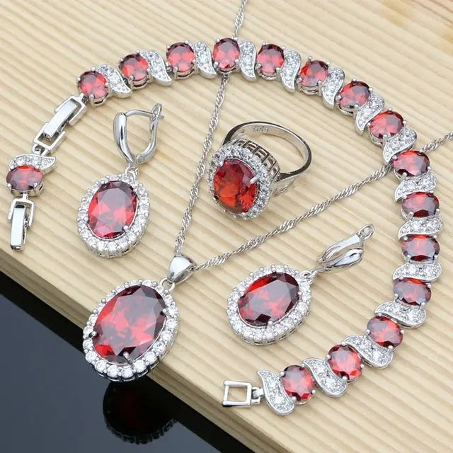 Silver jewelry set with red stones.