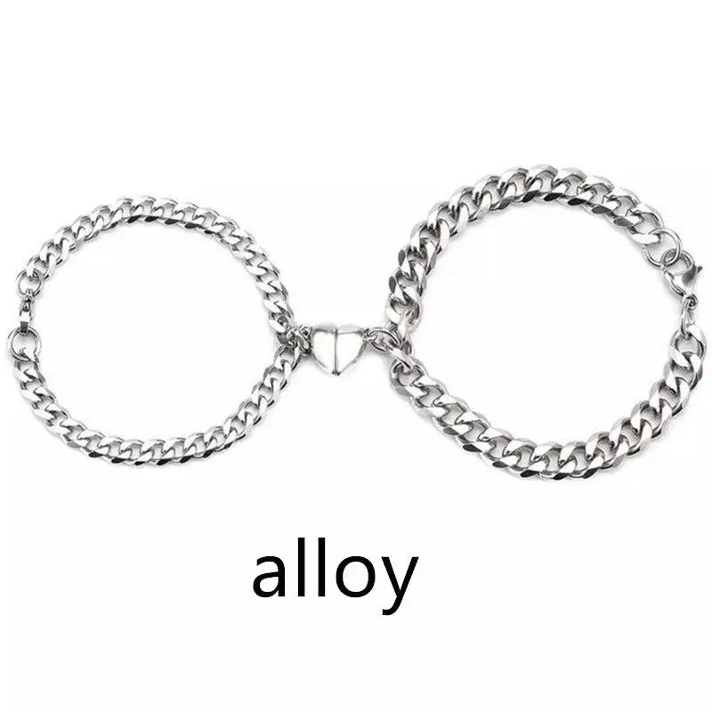 Two silver chain bracelets connected by a heart.