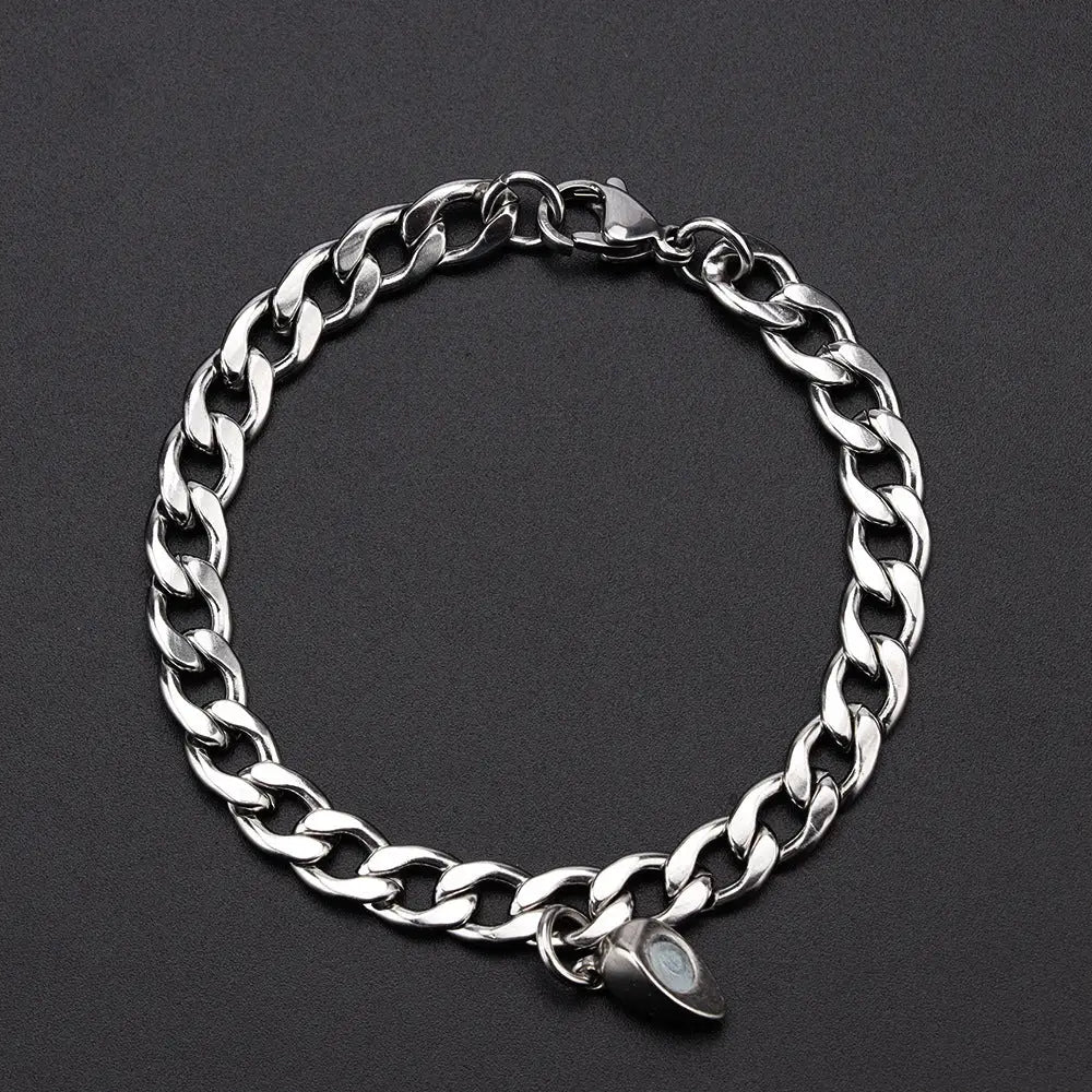 Silver chain bracelet with magnetic charm.