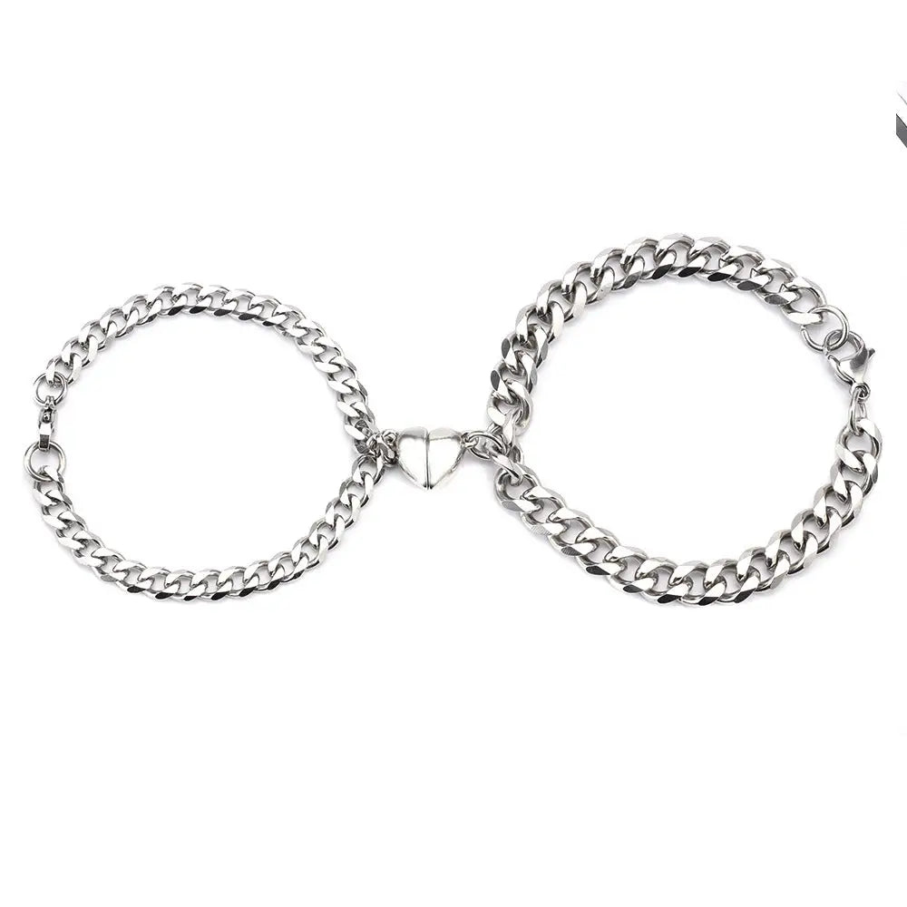 Silver chain couple bracelets with heart-shaped magnetic clasp.