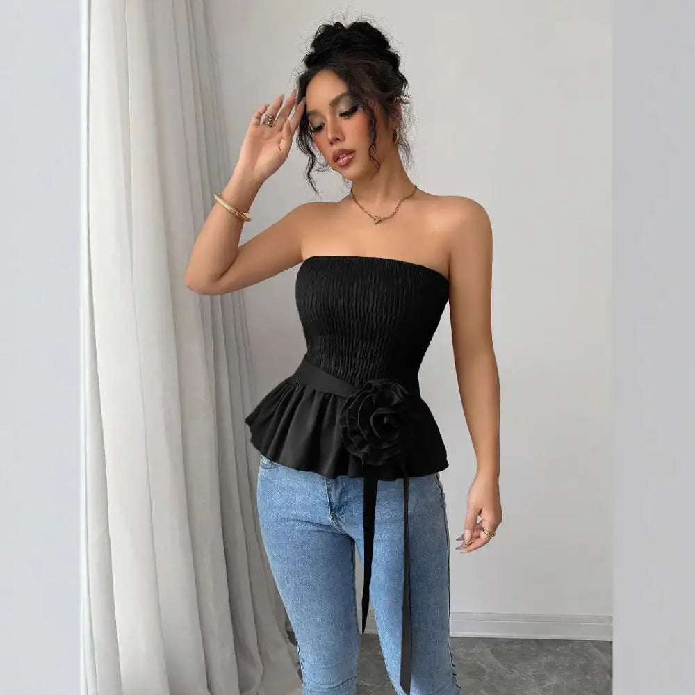 Woman in black strapless top and jeans.