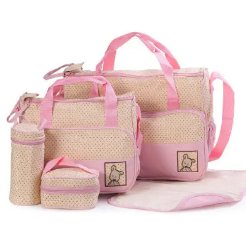 Pink and beige polka-dotted diaper bag set.