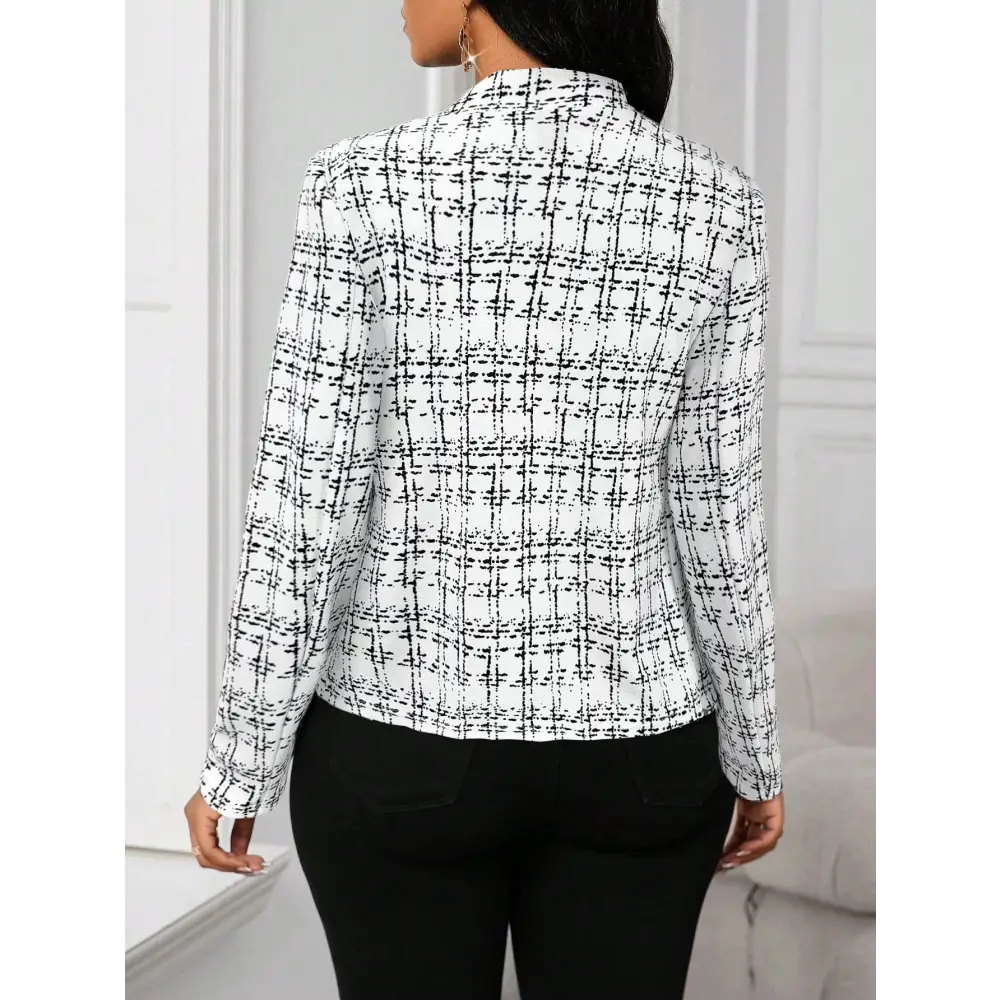 Woman’s black and white plaid blazer.