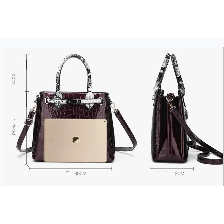 Burgundy crocodile-patterned handbag with snake-print handles.