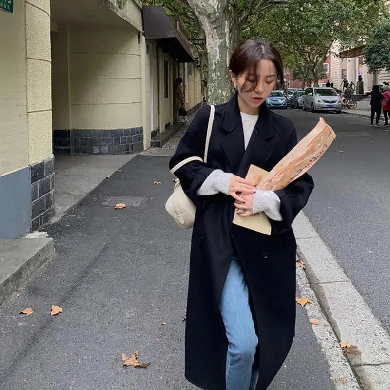 Woman’s long black coat.