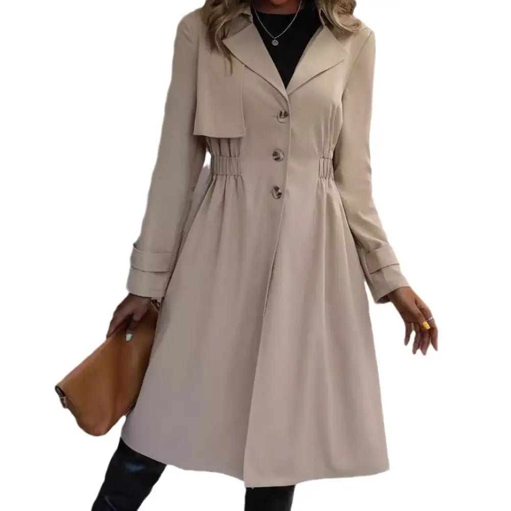 Beige trench coat with cinched waist.