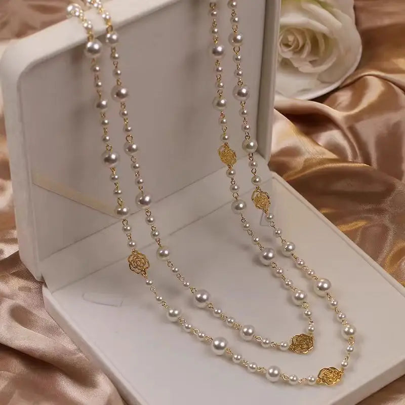Two pearl and gold necklaces.