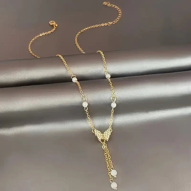 Butterfly Pearl Charm Necklace with Intricate Detailing - LauBelle