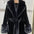 Black faux fur coat with belt.