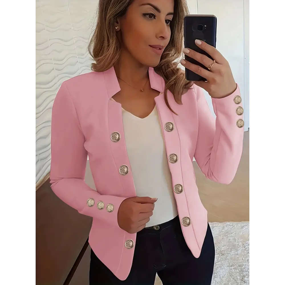 Pink blazer with decorative buttons.