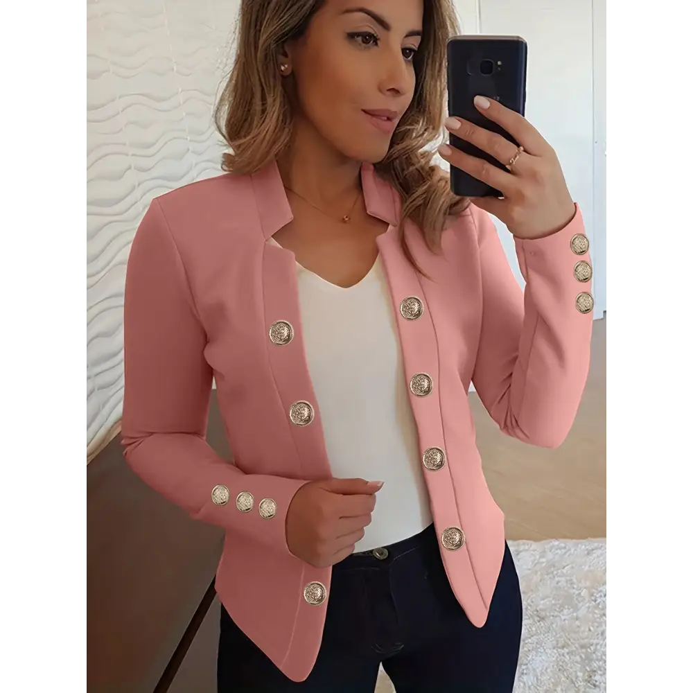 Pink blazer with decorative buttons.