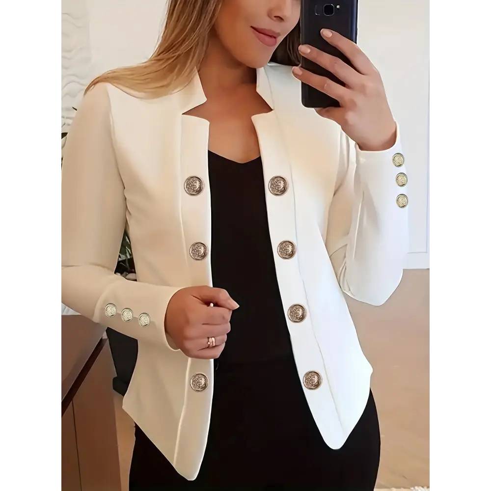 White blazer with decorative buttons.