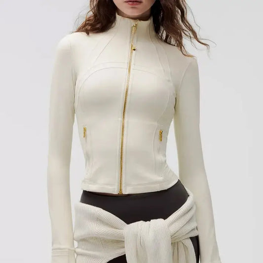 Cream-colored, long-sleeved zip-up jacket.