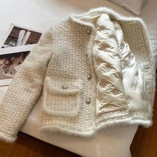 Cream-colored tweed jacket with faux fur trim.