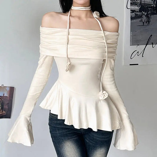 Off-the-shoulder cream top with long bell sleeves.
