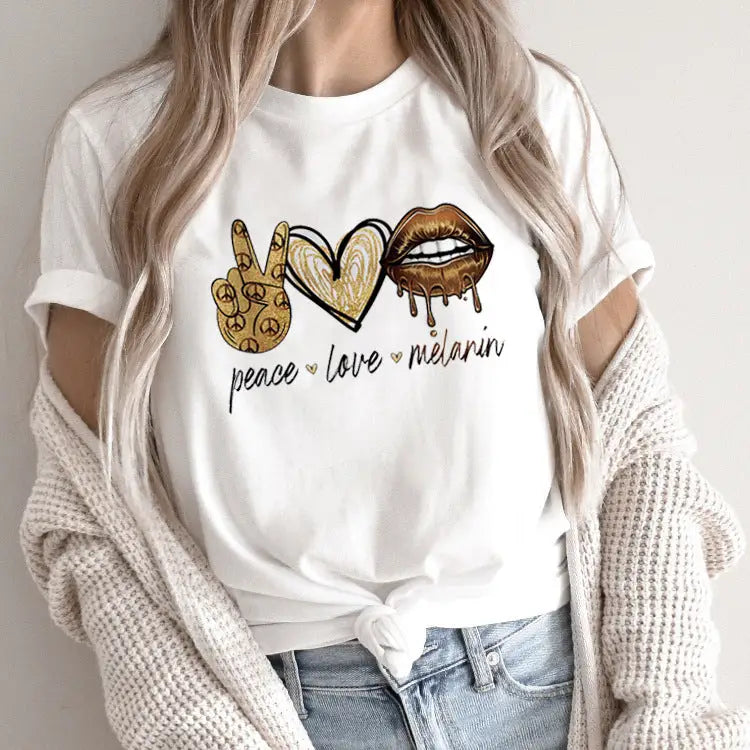 White t-shirt with ’peace love melanin’ graphic.