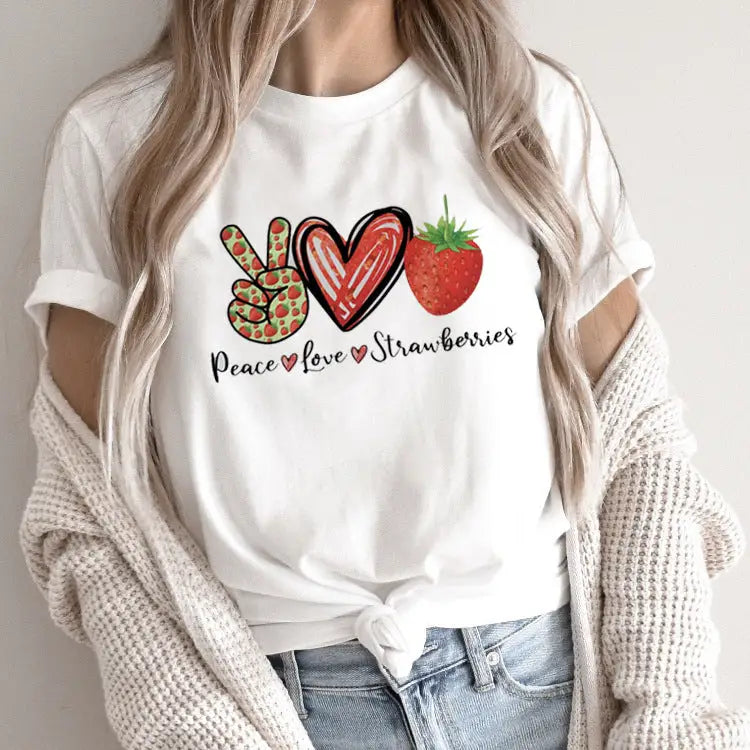 White t-shirt with strawberry-themed graphic.