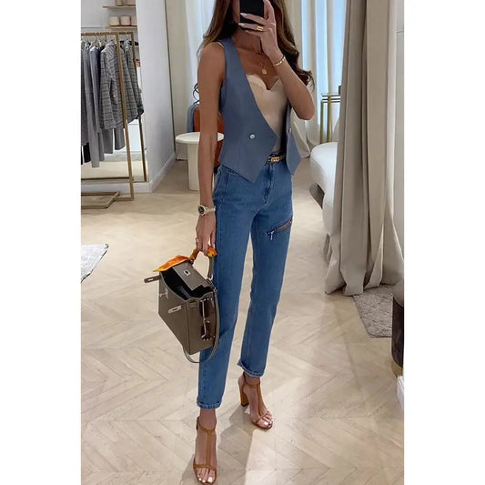 Woman’s denim vest and jeans outfit.