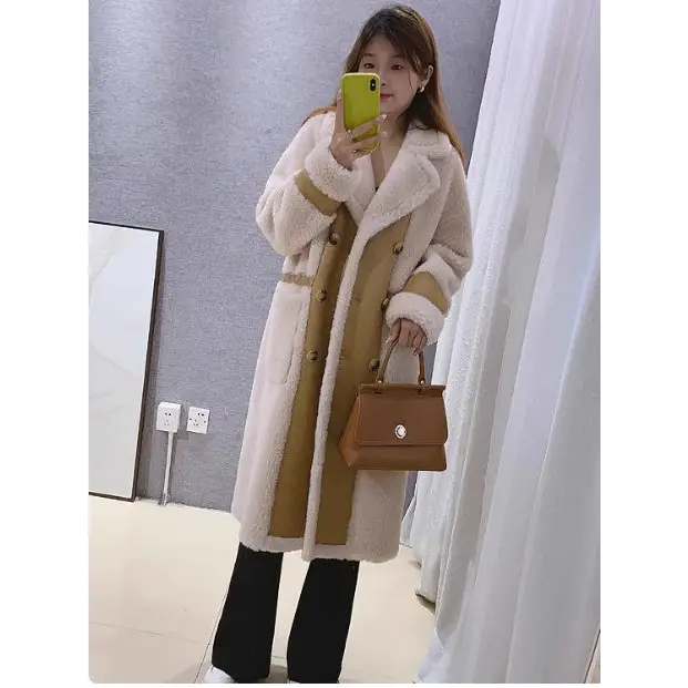 Woman’s long, double-breasted, faux fur coat with tan accents.