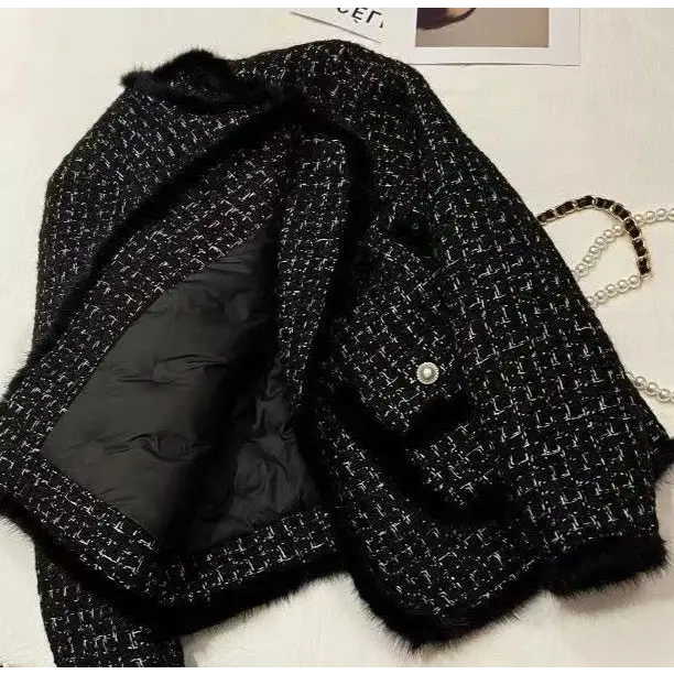 Black and white tweed jacket with fur trim.