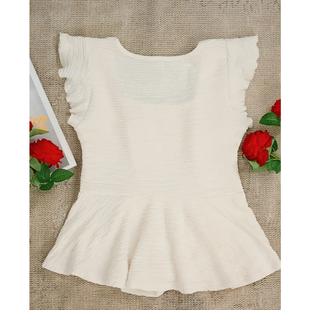 White textured peplum top.