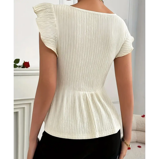 Cream-colored, textured peplum top.