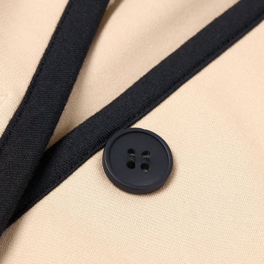 Beige fabric with black trim and button.