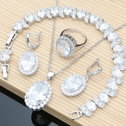 Silver jewelry set with oval-cut stones.