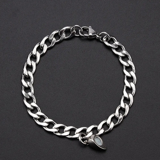 Silver chain bracelet with magnetic charm.