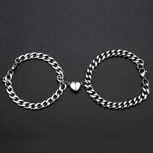 Matching silver chain bracelets with heart clasp.