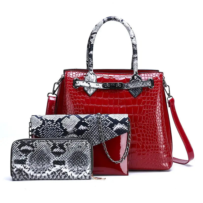 Red crocodile-patterned handbag with snake-print accents and matching wallet.