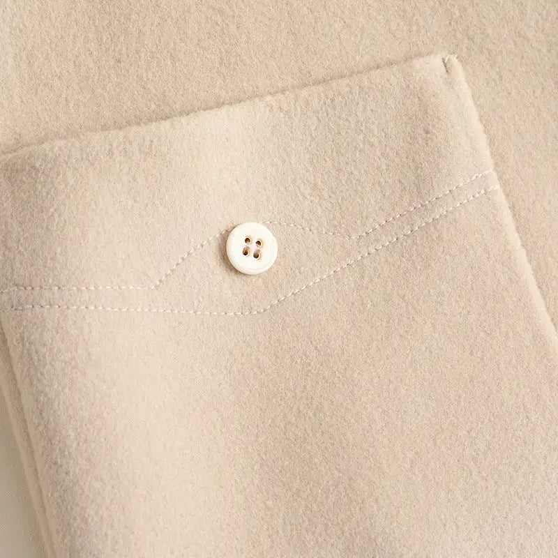 Beige fabric pocket with button.
