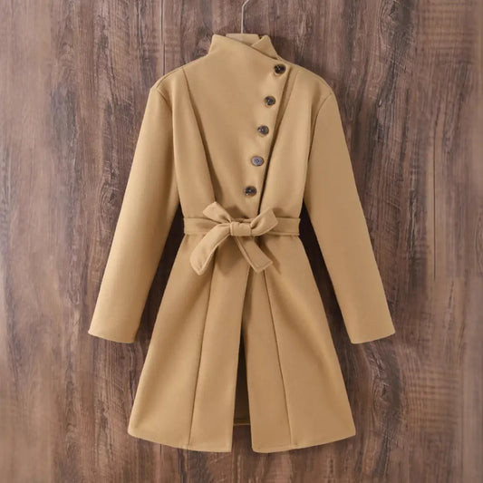 Tan belted coat with asymmetrical button closure.