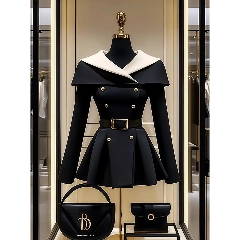 Black and white belted dress with matching handbags.