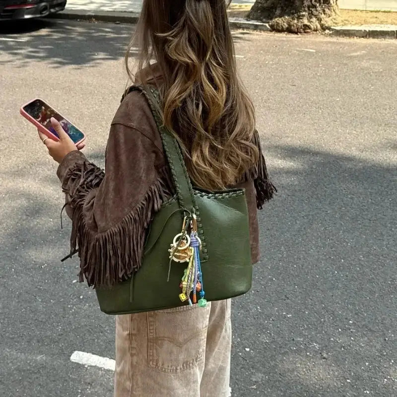 Olive green leather handbag with braided straps.