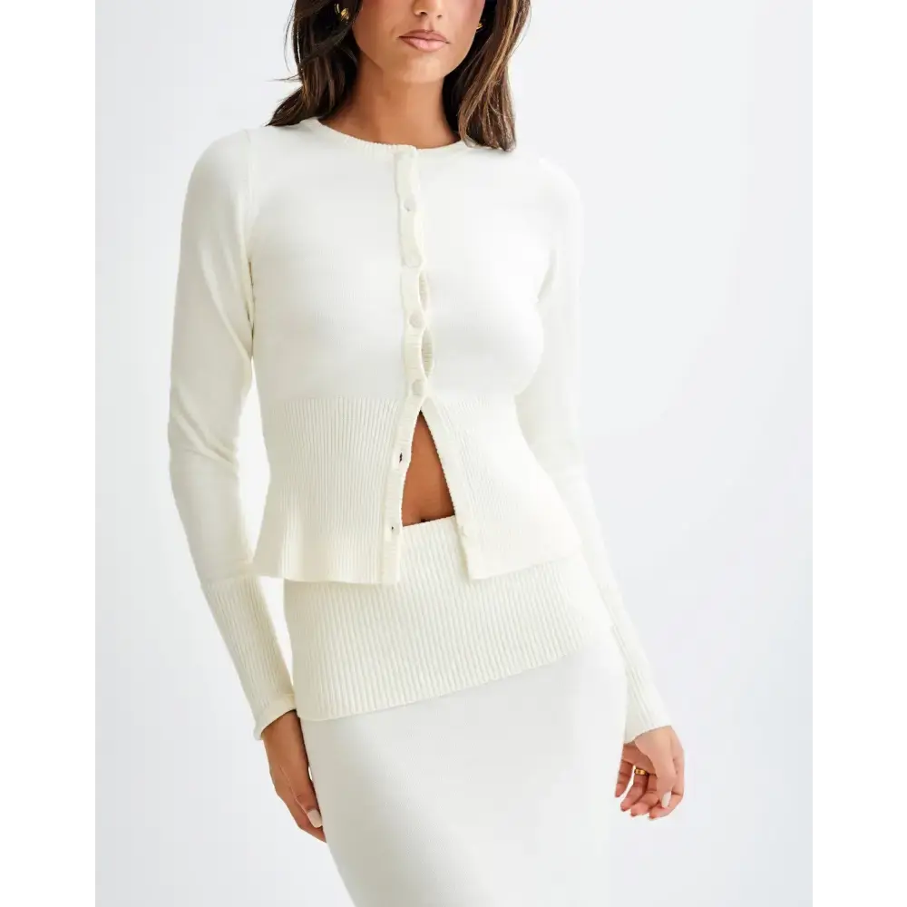 Cream-colored ribbed knit cardigan and skirt set.