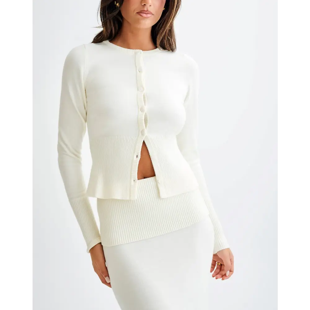 Cream-colored ribbed knit cardigan and skirt set.