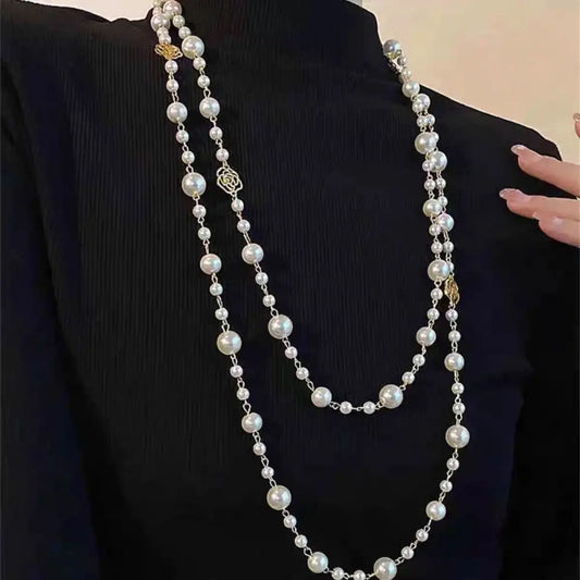 Double-strand pearl necklace with gold accents.
