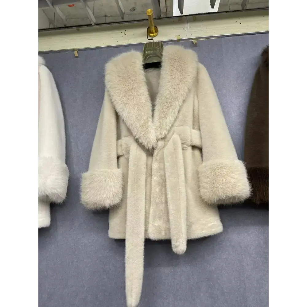 Cream-colored faux fur coat with a tie waist.