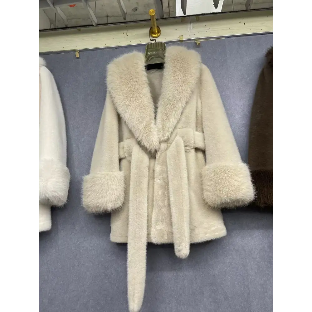 Cream-colored faux fur coat with a tie waist.