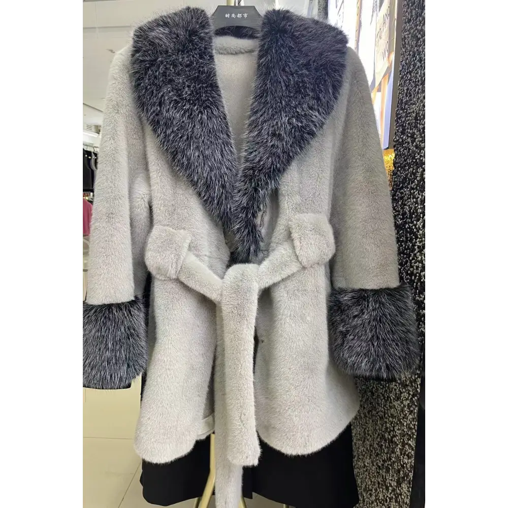 Gray faux fur coat with dark gray trim.