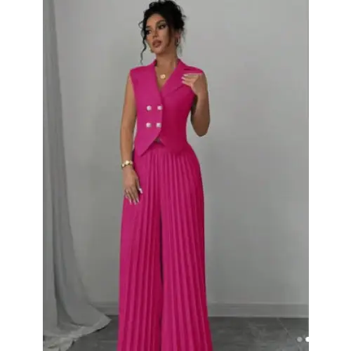 Woman in a pink vest and pleated pants.